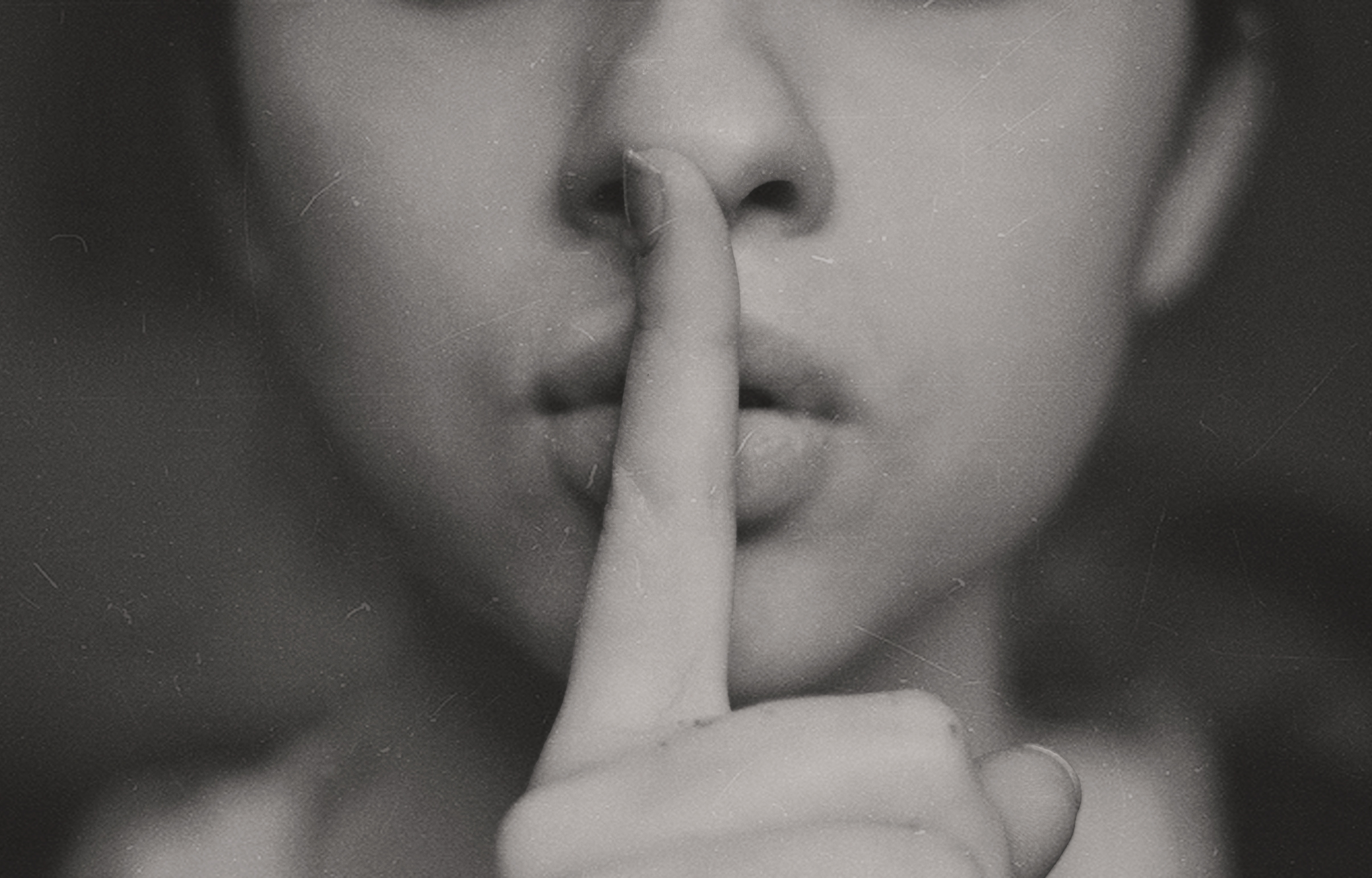 Woman with finger on lips