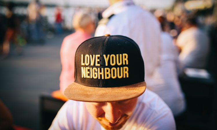 Man wearing hat that says Love Your Neighbor
