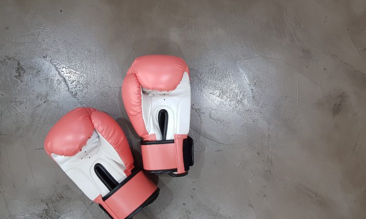 Pink boxing gloves on a gray surface
