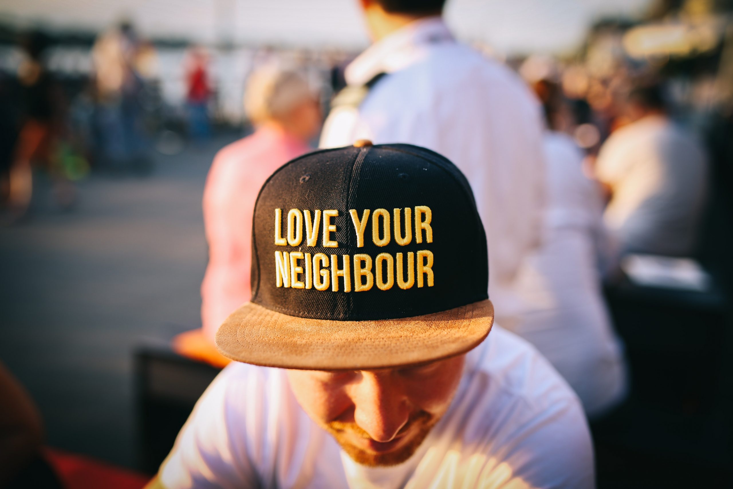Man wearing hat that says Love Your Neighbor